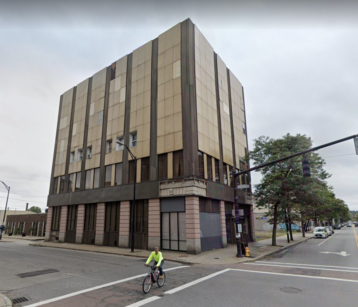 Ugly metal cladding system over two sides of the building covered all of the original brick, stone, and terra cotta panels.  